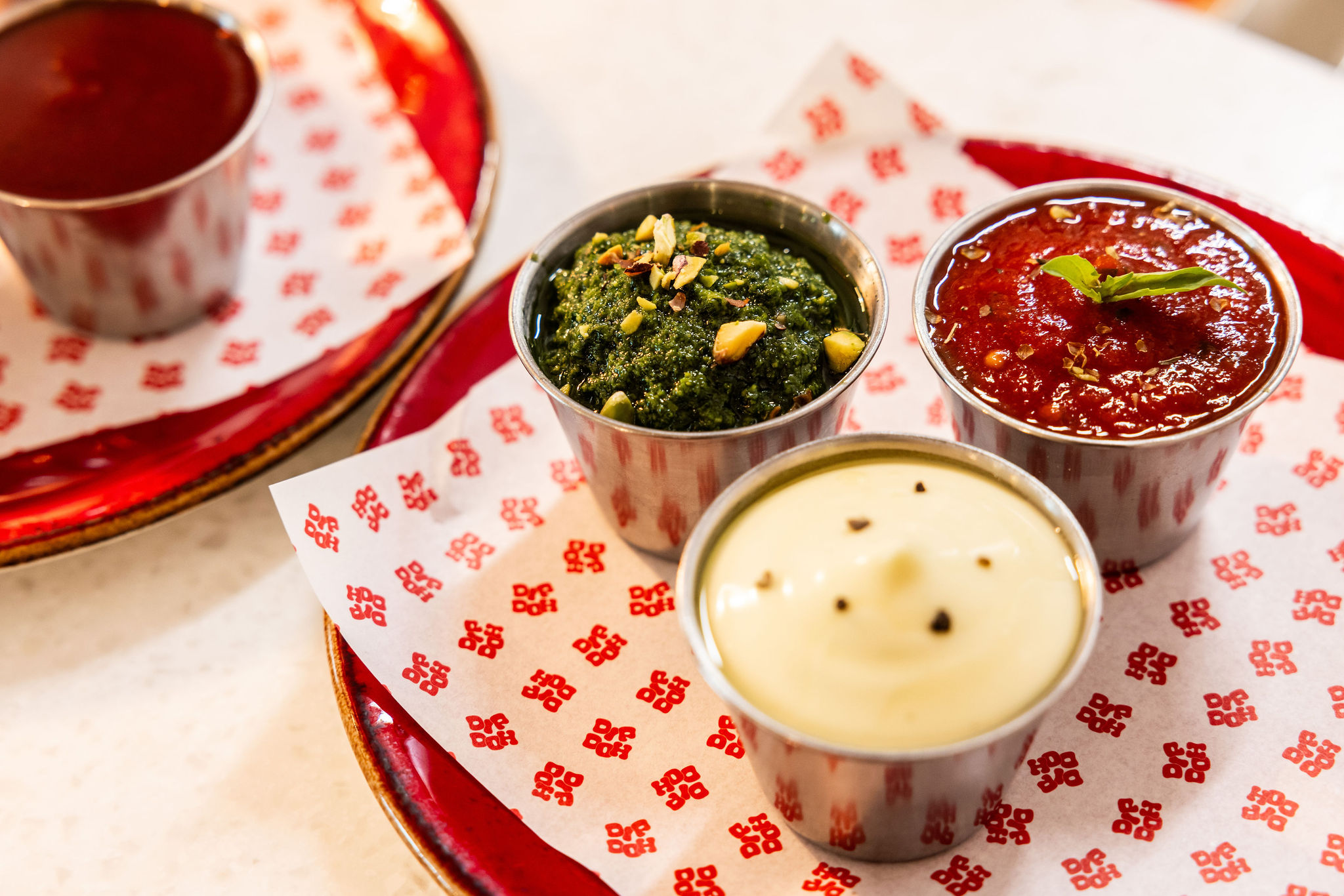 Three Dip Doh dipping sauces including pesto, tomato and creamy garlic dip.